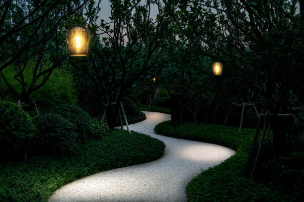 vintage lamps illuminated  footpath in the tranquil park at night. stock photo