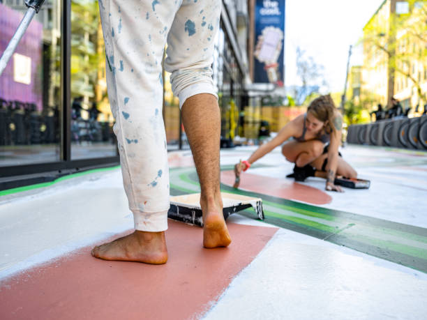 istock Young artists couple painting sidewalk mural 1397788000