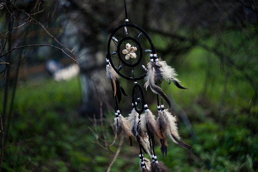 Dreamcatcher in forest, spiritual native american magical tool. Soft focus