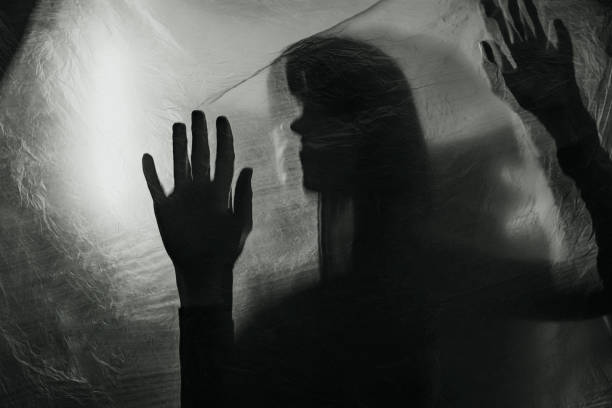 istock mysterious woman behind glass surface, creepy abstract concept 1397788163