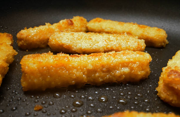 Chicken nuggets frying in a pan. Chicken nuggets frying in a pan. nuggets heat stock pictures, royalty-free photos & images