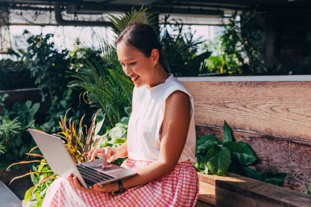 istock A Happy Businesswoman Working On Her Computer While Sitting On A Bench 1397789986
