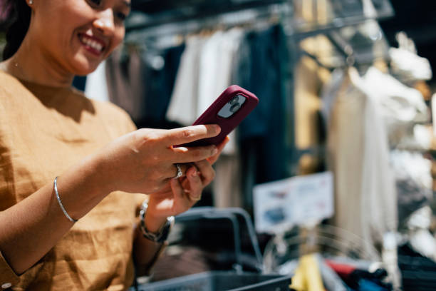 istock A Happy Businesswoman Using Her Mobile Phone While Shopping 1397790010