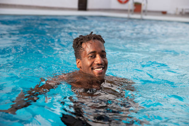 istock Black man enjoys the swimming pool during his vacation 1397790022