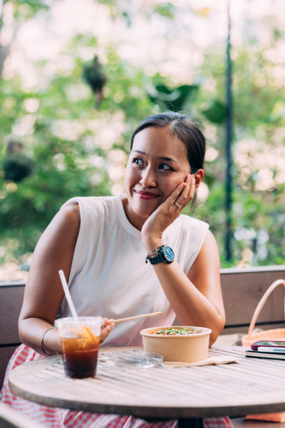 istock A Beautiful Businesswoman Looking Away While Having Lunch Using Chopsticks 1397790023