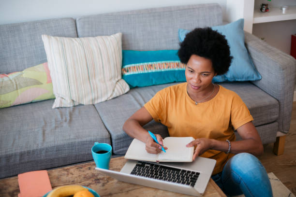 Middle aged woman working from home stock photo
