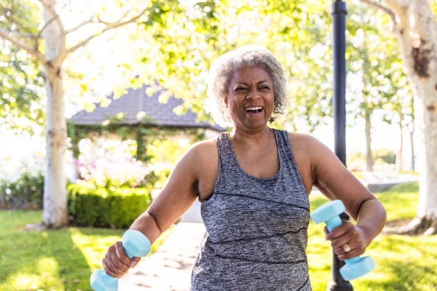 istock Senior black woman stretching and working out with weights 1397790415
