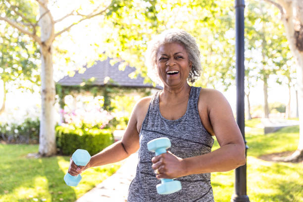 istock Senior black woman stretching and working out with weights 1397790417