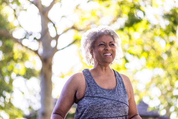 istock Senior black woman stretching and working out with weights 1397790428