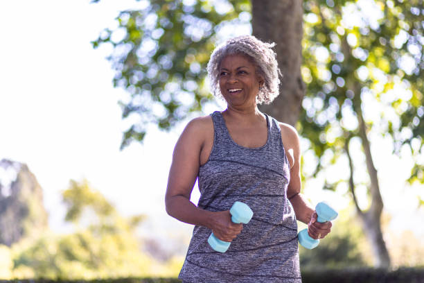 istock Senior black woman stretching and working out with weights 1397790463