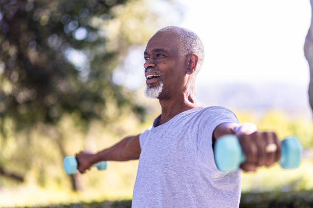 istock Senior black man working out with small weights 1397790485