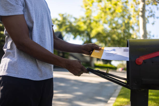 istock Senior black man mailing ballot for election 1397791155