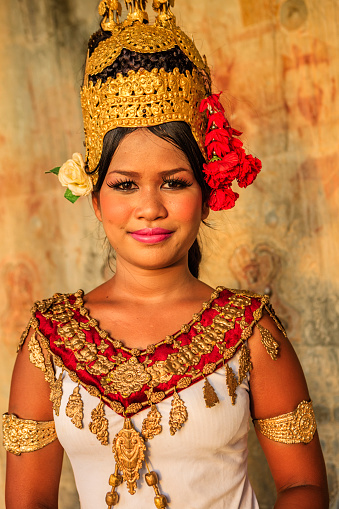 Young woman shows Apsara dance in old ruins near Siem Reap, Cambodia.