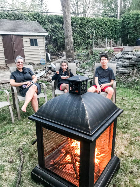 istock Mother and kids at the outdoors firepit 1397794046