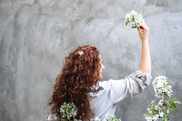 Young beautiful woman holding a bouquet of flowers