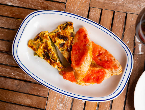 istock Zucchini tortilla skewer and bread with tomato pulp. Spanish dish closeup 1397797378