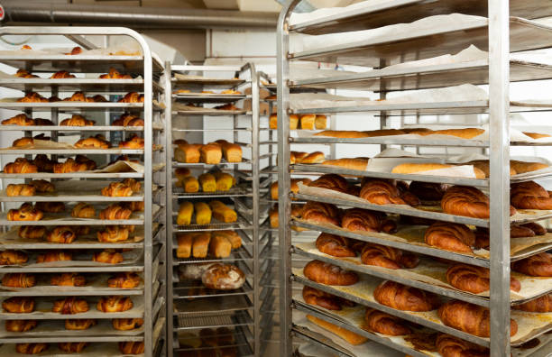 istock Freshly baked bread on trolley in bakery 1397797662