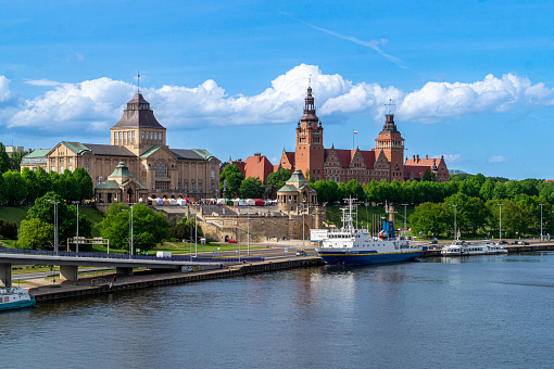 Szczecin, Poland - May 14, 2022: Beautiful view of ancient historical district of Szczecin, city on the Oder river. Boats moored at the pier