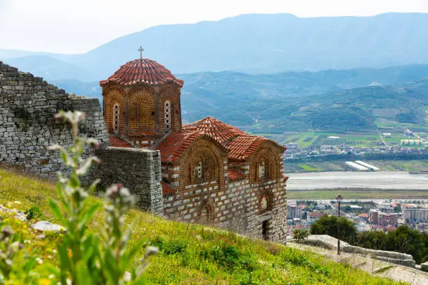 Medieval Byzantine Holy Trinity Church standing on hill in Berat city of Southern Albania on sunny spring day