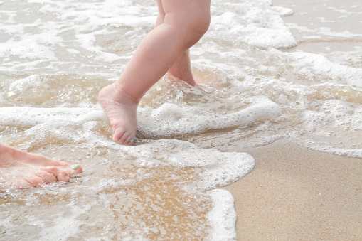 Feet on beach background. Top view on naked feet over the sand in Clearwater Beach, St. Petersburg, Florida, United States of America USA.\n\nHoliday, Summer and vacation holiday concept. Selfie male barefoot standing over white sand at the beach.