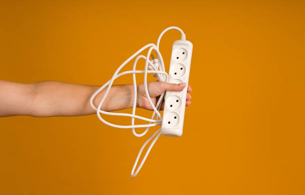 istock power strip with five sockets in hand on yellow background 1397798821