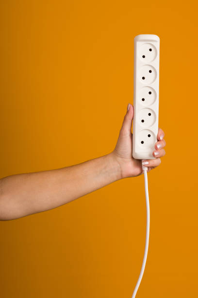 istock white electrical extension cord with sockets in hand on yellow background 1397798833