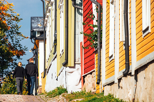 Porvoo, Finland  -  A couple enjoying walking in old town, district with only wooden buildings.