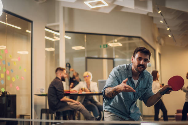 istock Young people playing table tennis in the office at work 1397799878