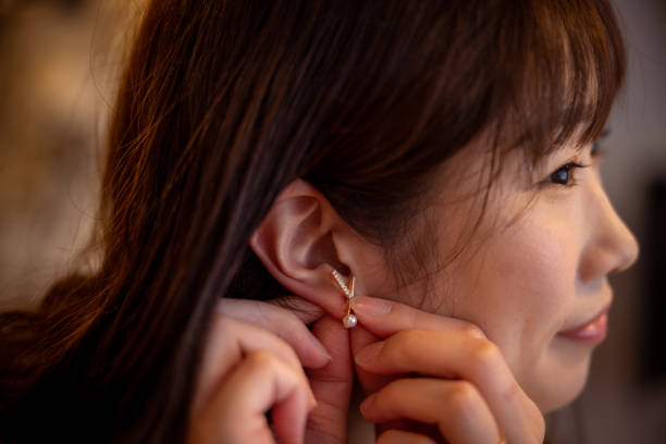 istock Woman putting on earring 1397800855