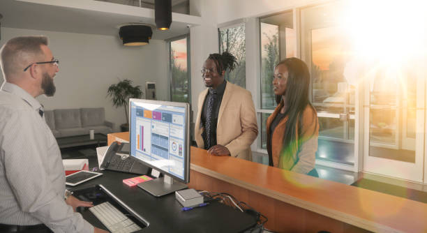 istock Couple checking in to reception desk 1397802755