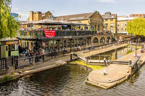 The lock, often called 'Camden Lock' is the only twin lock in London, flanked on one side by Camden Market, with weeping willows sweeping over the roving bridge.