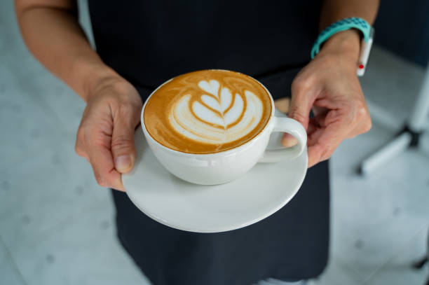 istock hot latte art coffee on hand table, relax time 1397807841