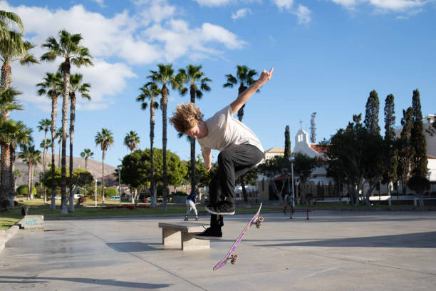 istock Skater perform a kickflip while riding his skateboard at the skatepark. 1397807935