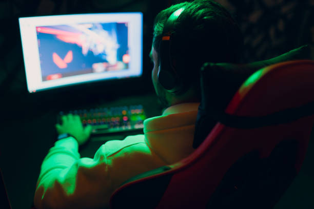 istock Guy playing gaming game on computer at game club 1397808737