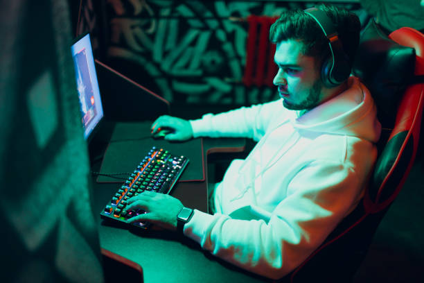 istock Guy playing gaming game on computer at game club 1397808738