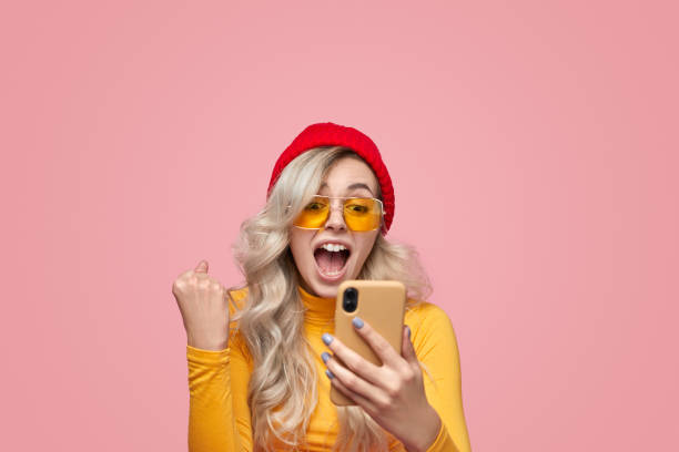 istock Excited woman with smartphone celebrating victory 1397808896