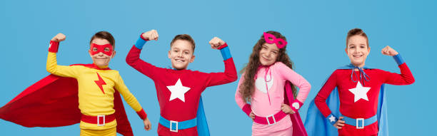 istock Cheerful kids in hero costumes showing superpowers 1397808953