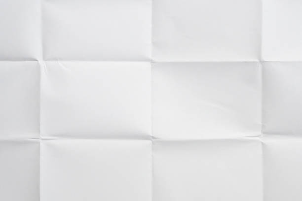 istock White folded and wrinkled paper texture background 1397808996