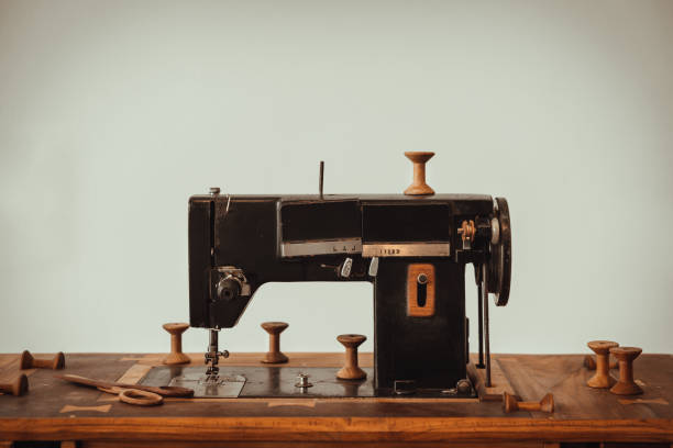 istock Old vintage sewing machine on wooden table on white wall background. 1397809321