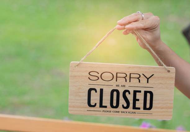istock woman holding close label with blur background 1397810090