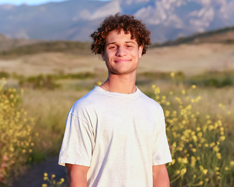Multiracial teenage boy in wildflowers