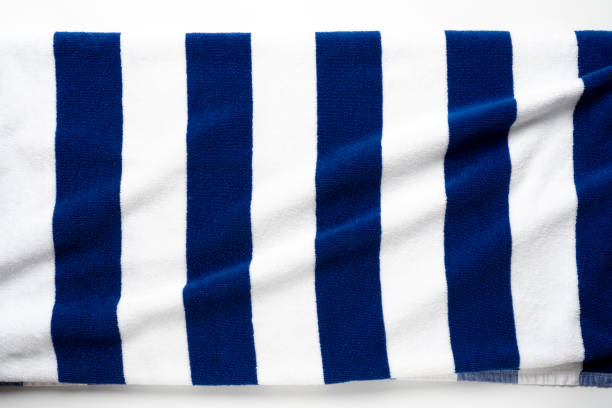 istock Blue stripped beach towel isolated on white, flat lay top view shot 1397812293