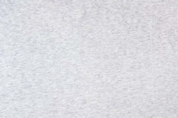 Grey knitted fabric cotton textured background. Closeup with copy space for your design Grey knitted fabric cotton textured background. Close up with copy space for your design heather grey stock pictures, royalty-free photos & images