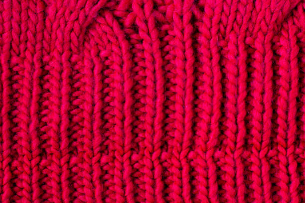 istock Red knitted woolen background for your design. Knit fabric pattern of sweater 1397815571