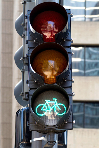 Green bike light in an urban cyclist road lane in Chicago. Urban bicycle ridding signaling go. Cyclist traffic light for bicycle people.