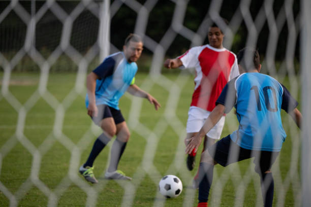istock Soccer player trying to score a goal while playing a game 1397817675