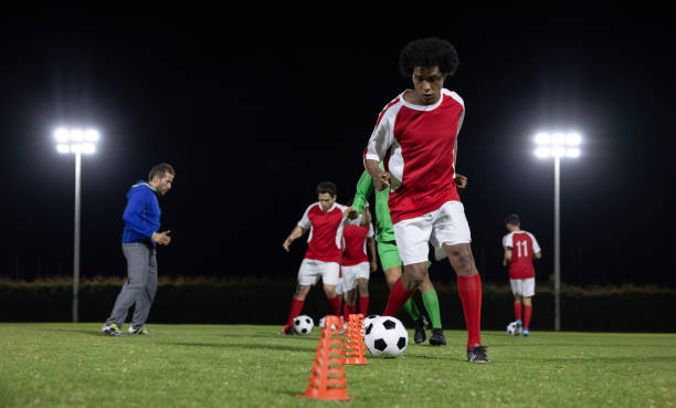 istock Soccer players training in the field at nighttime 1397817687