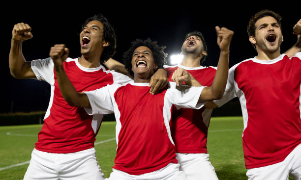 istock Excited group of soccer players celebrating scoring a goal 1397817708