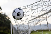 istock Goal!!! Soccer ball hitting the goal net after scoring 1397817779