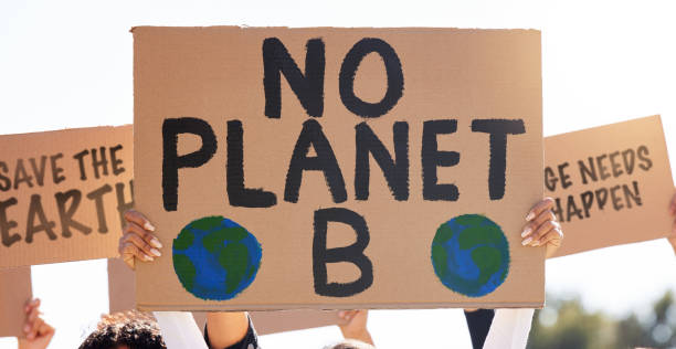 istock Shot of a group of people protesting climate change 1397818426